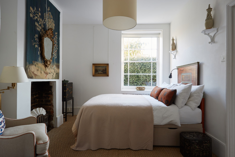 Inspiration for a classic bedroom with white walls and brown floors.