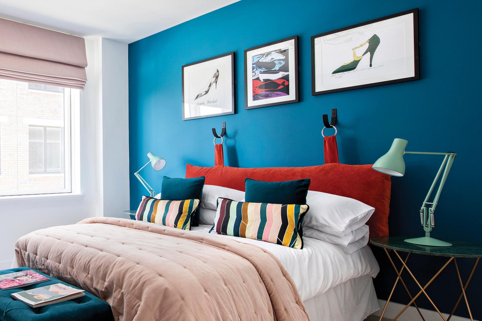 Contemporary bedroom in London with blue walls.