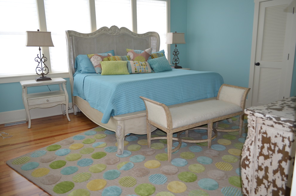 Photo of a beach style guest bedroom in Other with blue walls.