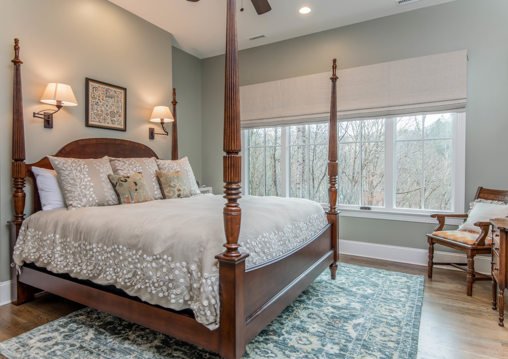 This is an example of a medium sized traditional master bedroom in Other with blue walls, dark hardwood flooring and brown floors.