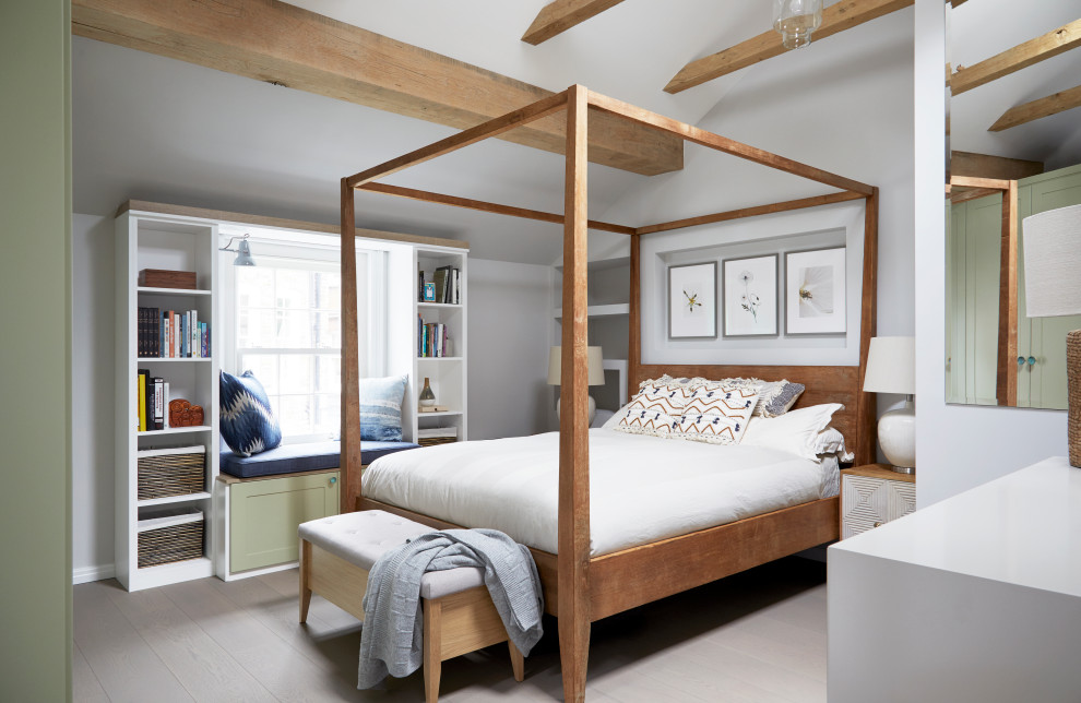 This is an example of a small traditional master bedroom in London with grey walls, light hardwood flooring and grey floors.