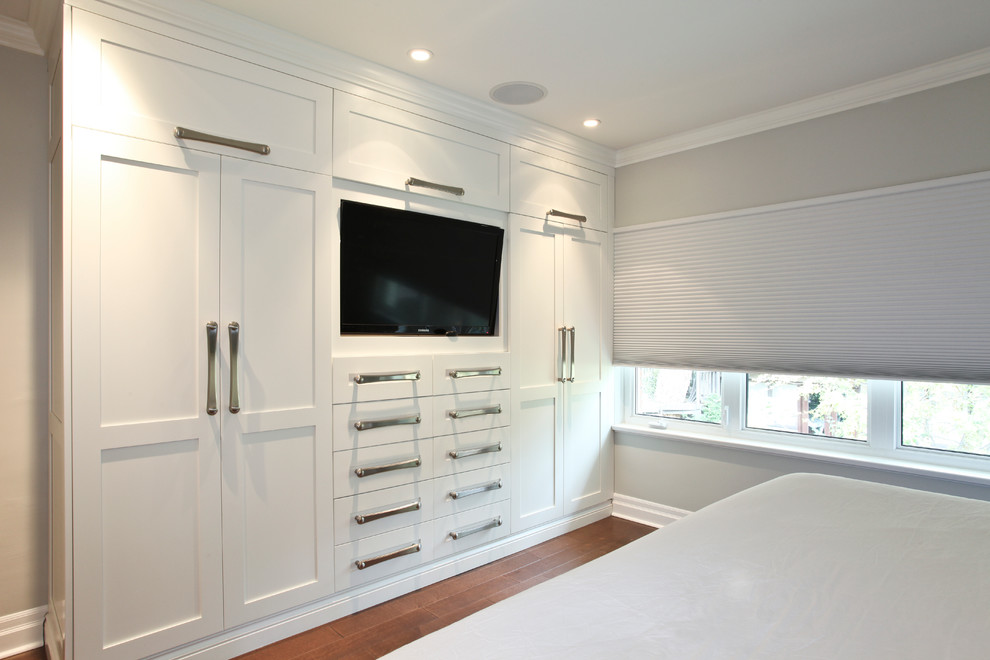 Example of a mid-sized trendy master medium tone wood floor bedroom design in Montreal with gray walls