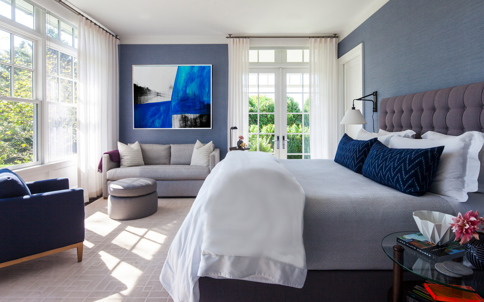 Example of a large transitional master bedroom design in New York with blue walls and no fireplace