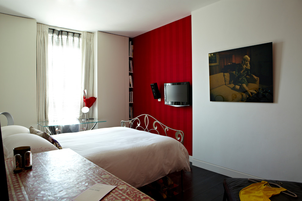 Photo of a large contemporary guest bedroom in London with red walls, dark hardwood flooring and brown floors.