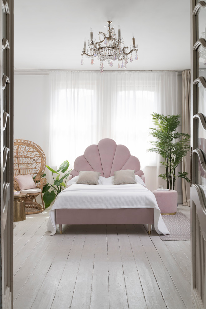 This is an example of a contemporary grey and pink bedroom in London with white walls, painted wood flooring and grey floors.