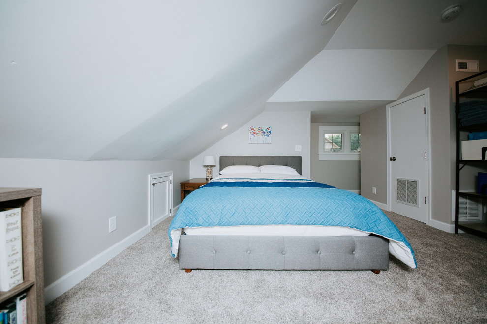Medium sized traditional guest loft bedroom in Omaha with grey walls, carpet, no fireplace and grey floors.