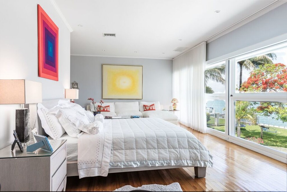 Inspiration for a contemporary medium tone wood floor bedroom remodel in Miami with gray walls