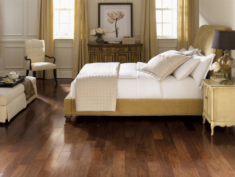 Example of a large transitional master medium tone wood floor bedroom design in New York with white walls and no fireplace