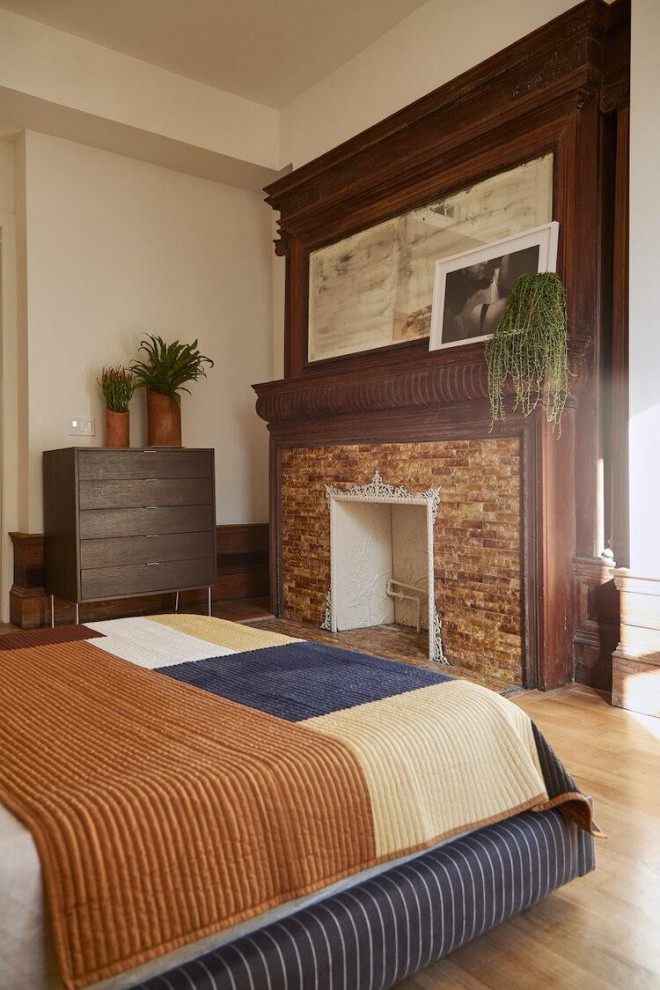 Ejemplo de dormitorio principal contemporáneo grande con paredes beige, suelo de madera en tonos medios, todas las chimeneas, marco de chimenea de baldosas y/o azulejos y suelo marrón
