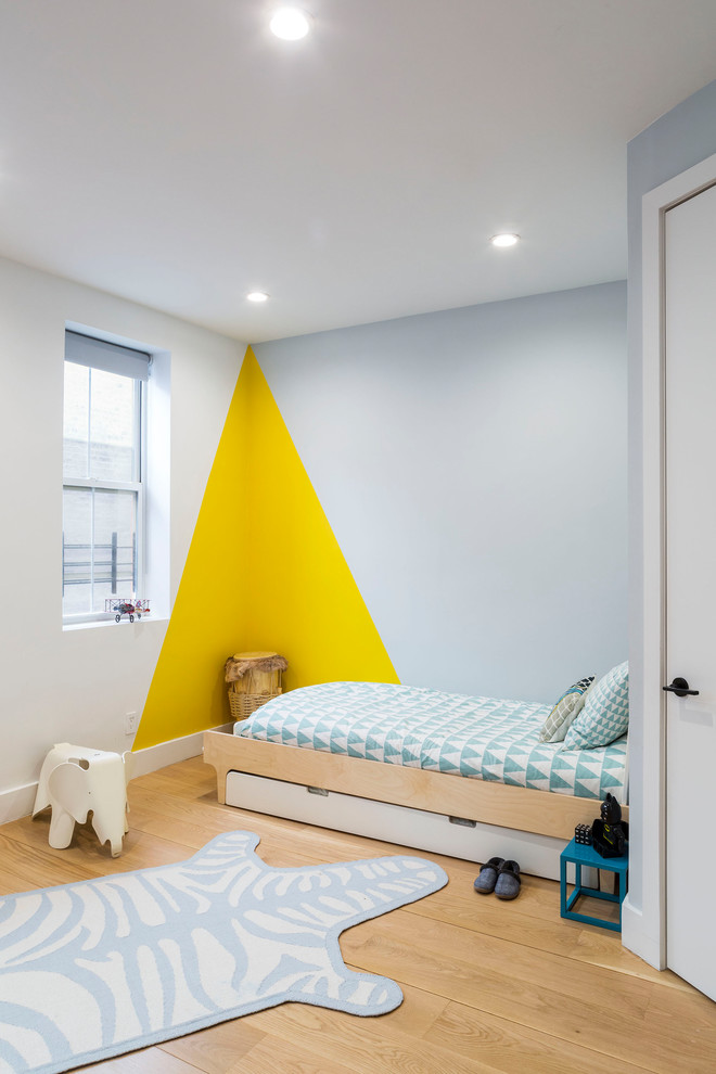 This is an example of a medium sized contemporary guest bedroom in New York with multi-coloured walls, light hardwood flooring, no fireplace and beige floors.