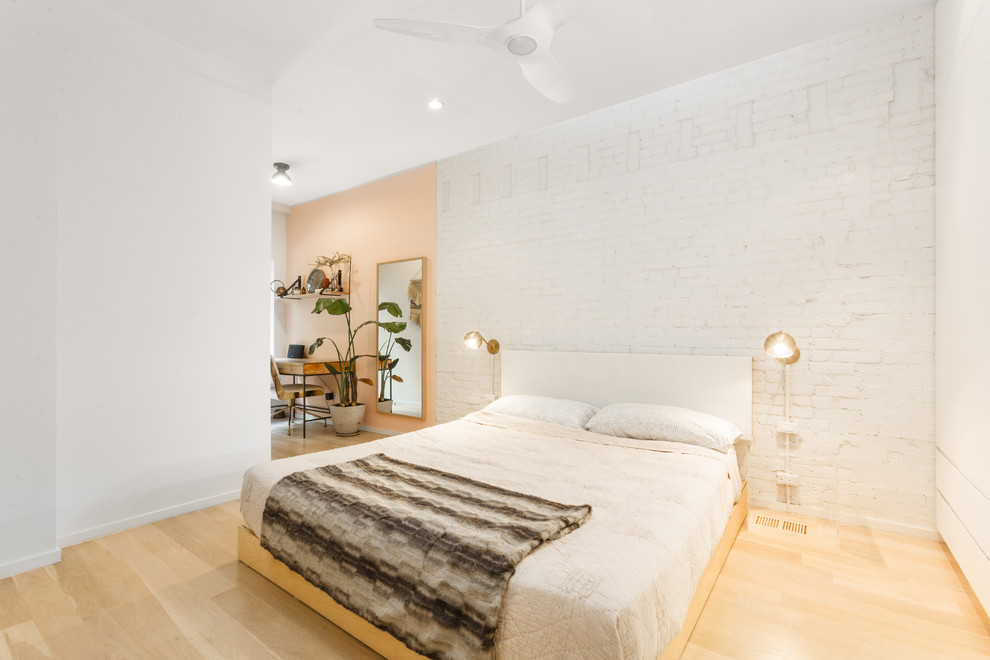 Photo of a medium sized scandi master bedroom in New York with white walls and light hardwood flooring.