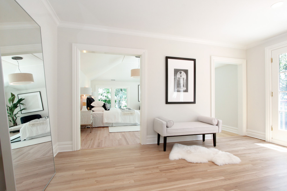 Photo of a medium sized traditional master bedroom in New York with white walls, medium hardwood flooring, beige floors and a vaulted ceiling.
