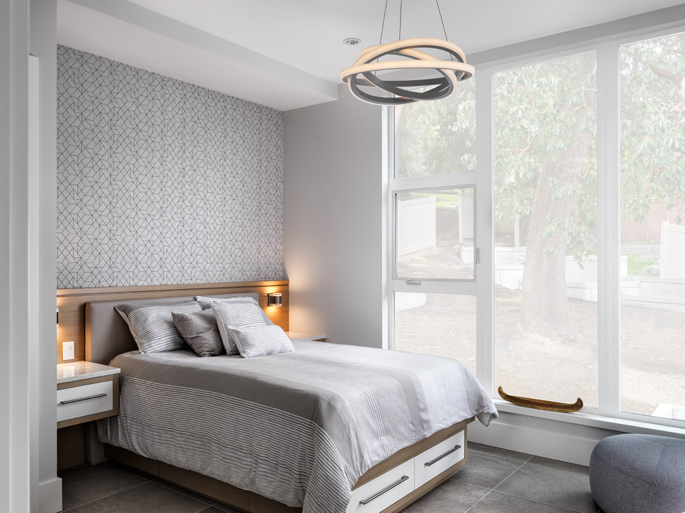 Modern inredning av ett sovrum, med grå väggar och grått golv