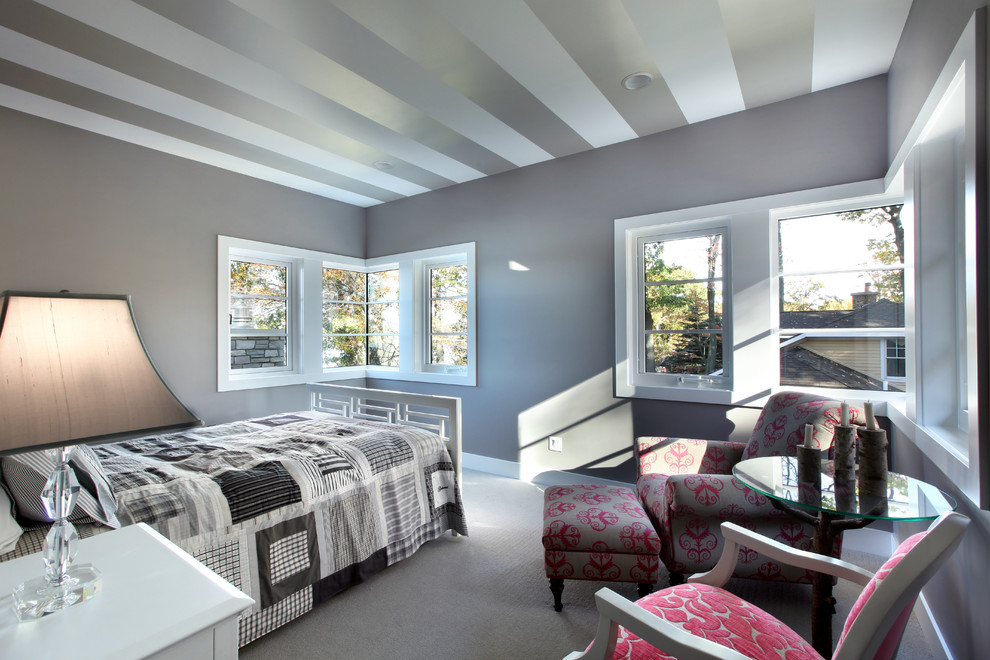 Example of a large trendy guest carpeted bedroom design in Grand Rapids with gray walls and no fireplace