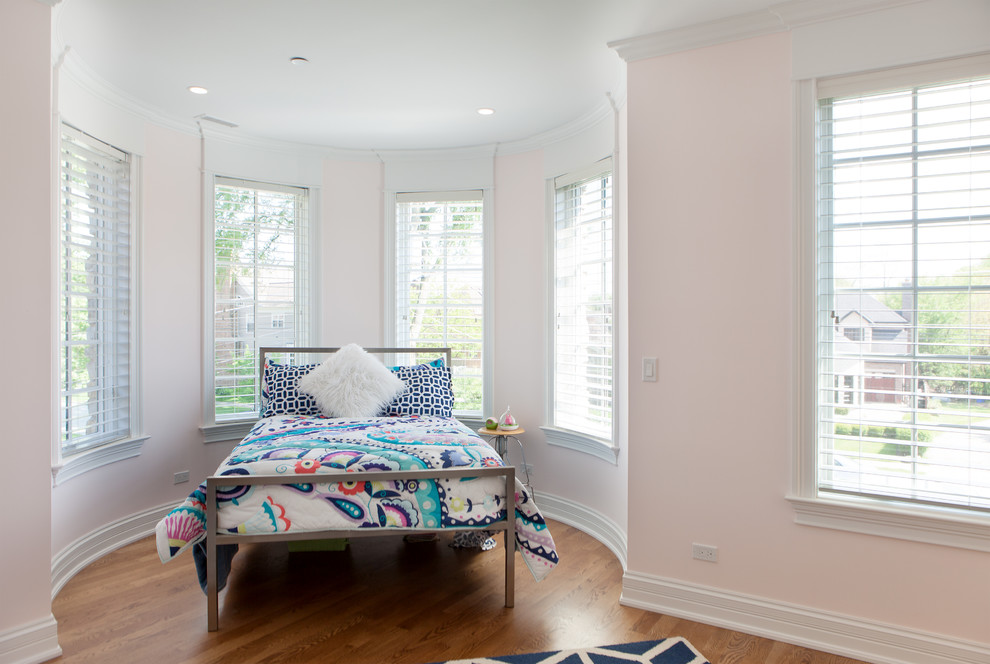 Inspiration for a mid-sized contemporary guest light wood floor bedroom remodel in Chicago with pink walls and no fireplace