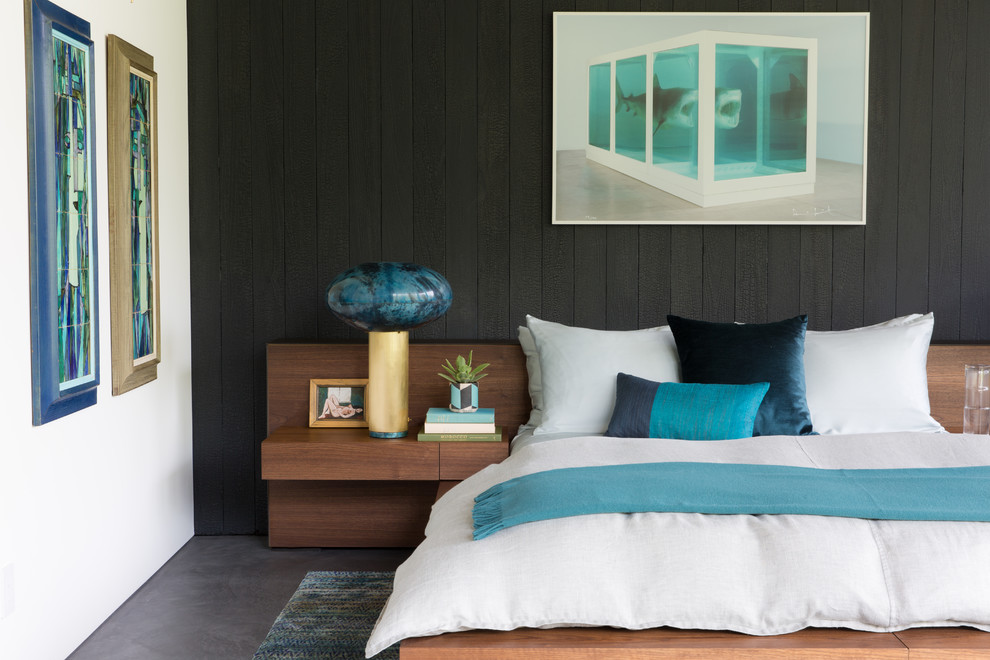 Идея дизайна: спальня в современном стиле с черными стенами, бетонным полом, серым полом и акцентной стеной