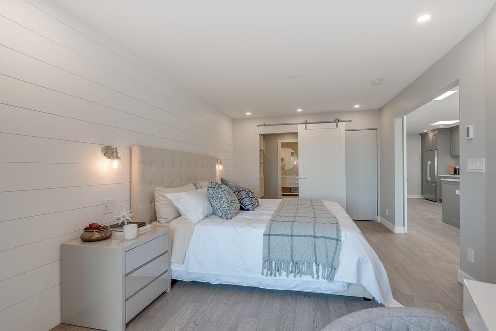 Photo of a medium sized nautical master bedroom in Vancouver with grey walls, light hardwood flooring and grey floors.