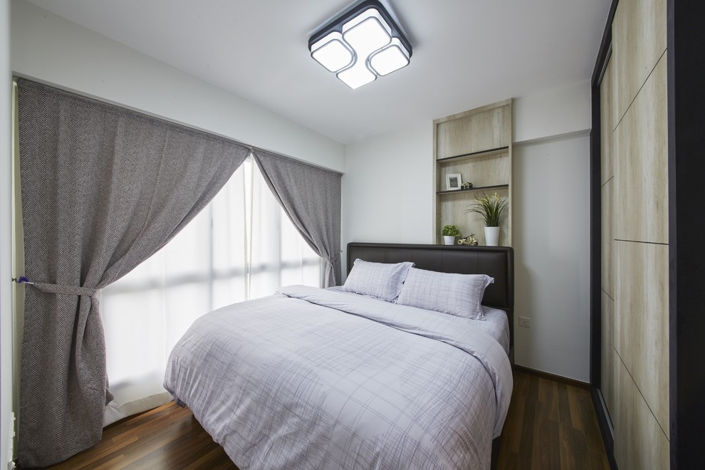 Ispirazione per una camera da letto scandinava di medie dimensioni con pareti verdi e pavimento in legno massello medio