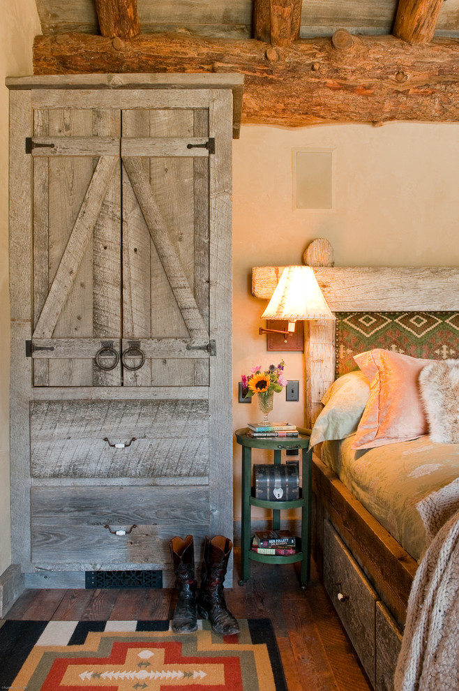 Photo of a rustic bedroom in Other with beige walls.