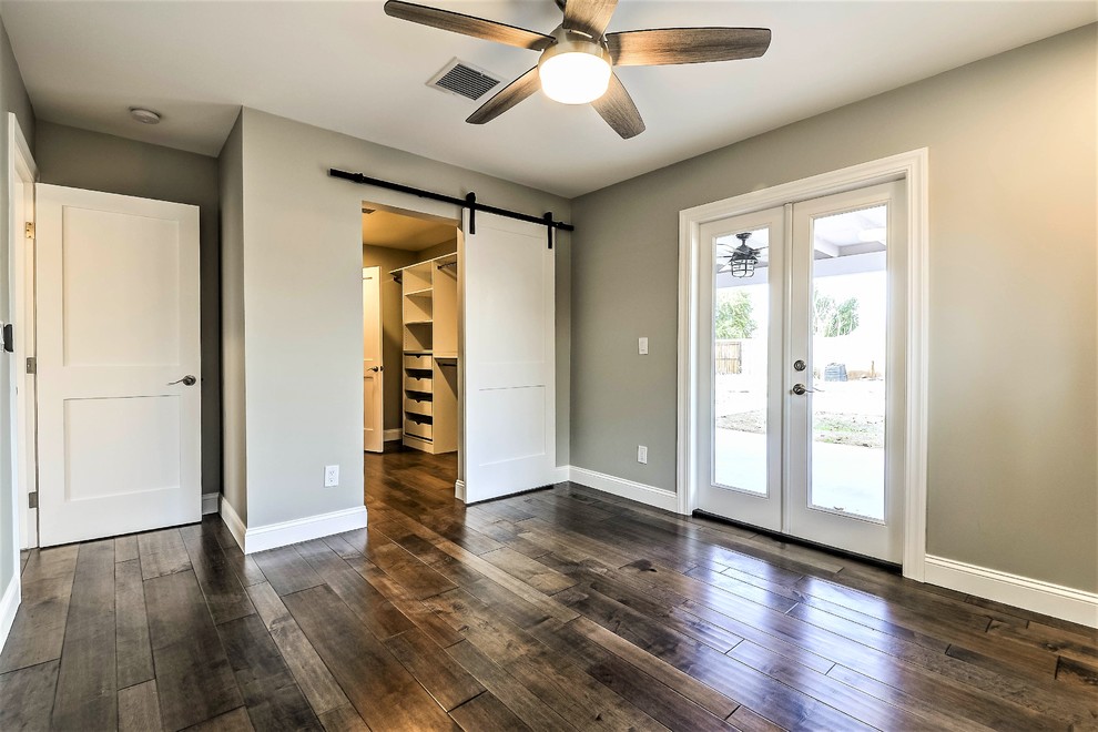 Medium sized classic master bedroom in Phoenix with grey walls, dark hardwood flooring and brown floors.