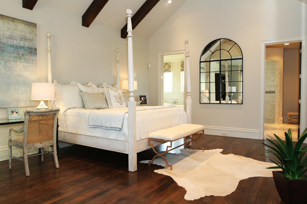 Elegant master bedroom photo in Houston with white walls and a standard fireplace