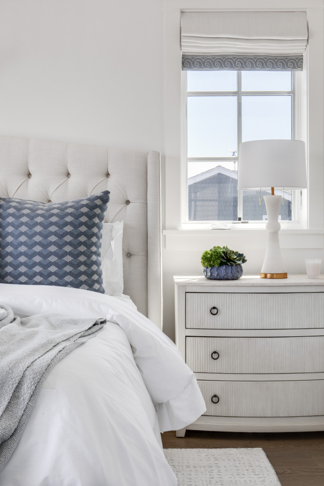 Inspiration for a coastal bedroom in Orange County with white walls, dark hardwood flooring and brown floors.