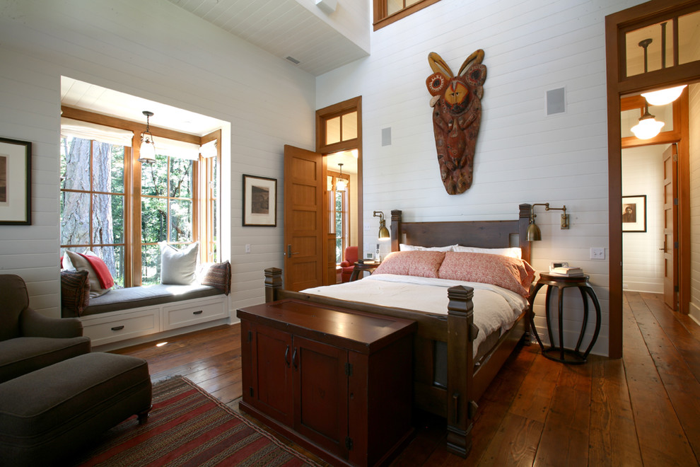 Example of a mountain style medium tone wood floor bedroom design in Seattle with white walls and no fireplace
