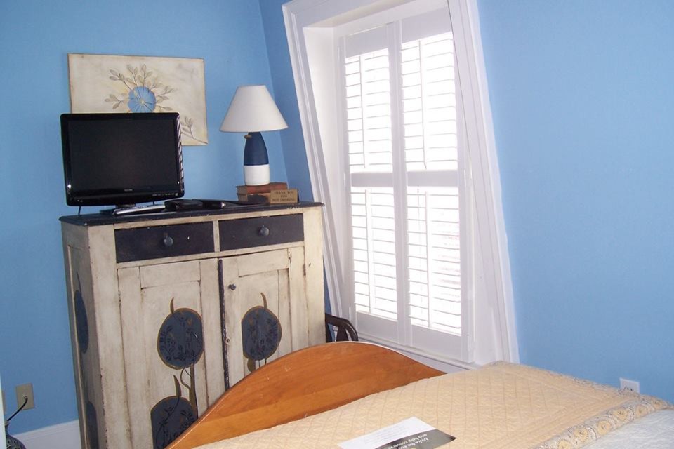 Photo of a medium sized traditional guest bedroom in Boston with blue walls.