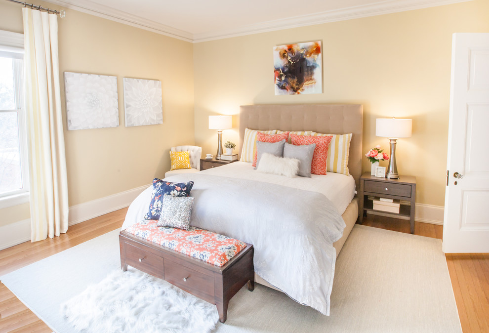 Klassisches Hauptschlafzimmer mit gelber Wandfarbe, braunem Holzboden und orangem Boden in Grand Rapids