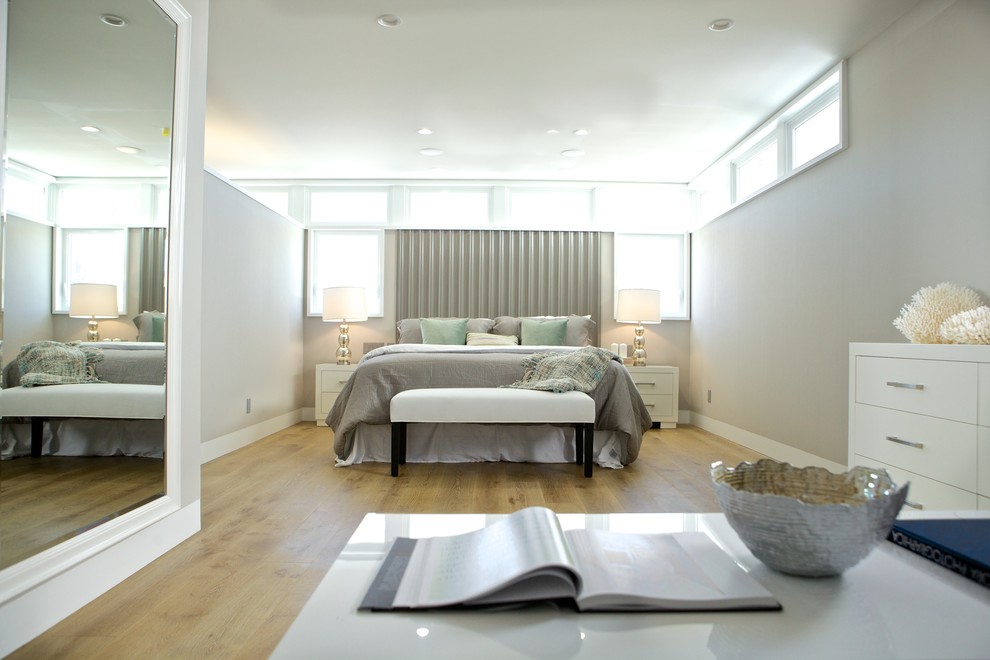 Bedroom - large coastal master light wood floor bedroom idea in Los Angeles with white walls
