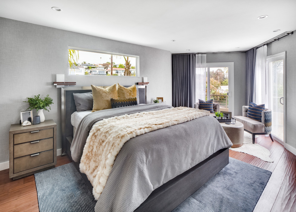 This is an example of a large modern master and grey and brown bedroom in Orange County with grey walls, dark hardwood flooring, no fireplace and brown floors.