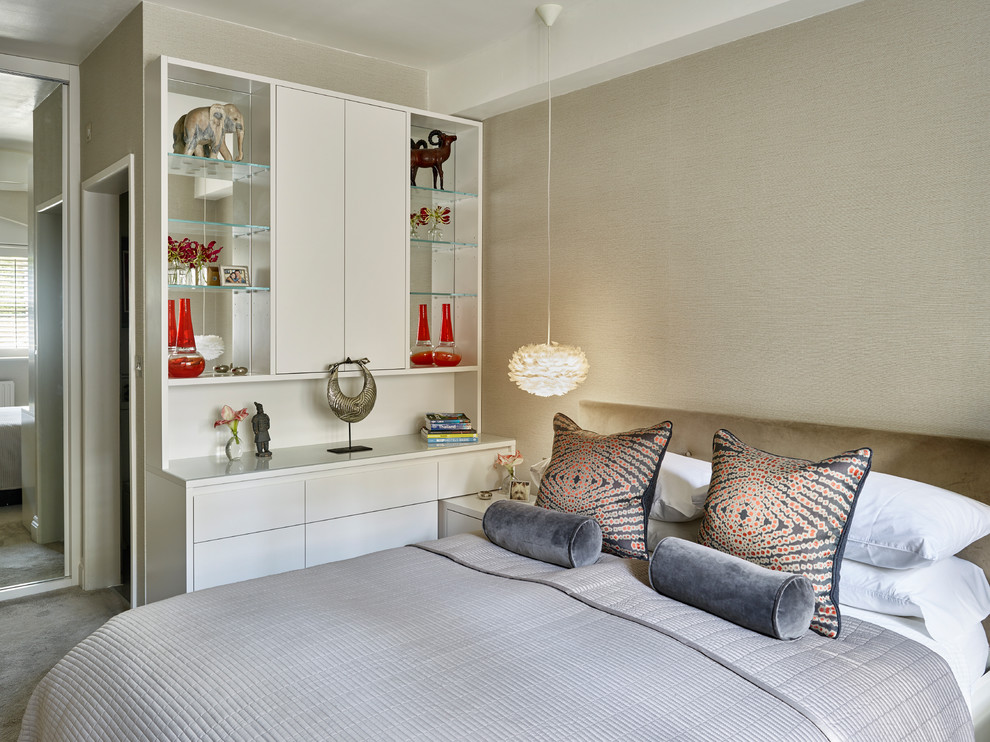 Design ideas for a contemporary master bedroom in London with beige walls, carpet and grey floors.