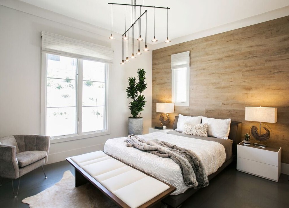Example of a mid-sized trendy guest concrete floor and gray floor bedroom design in Orange County with beige walls and no fireplace