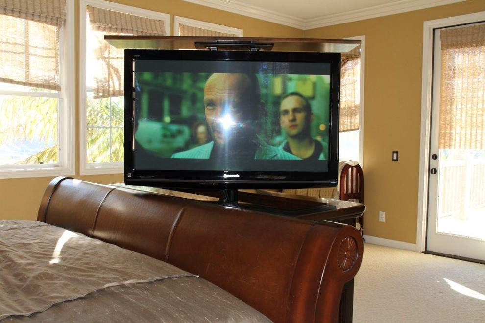 Hidden TV in furniture at the foot of the bed with TV lift