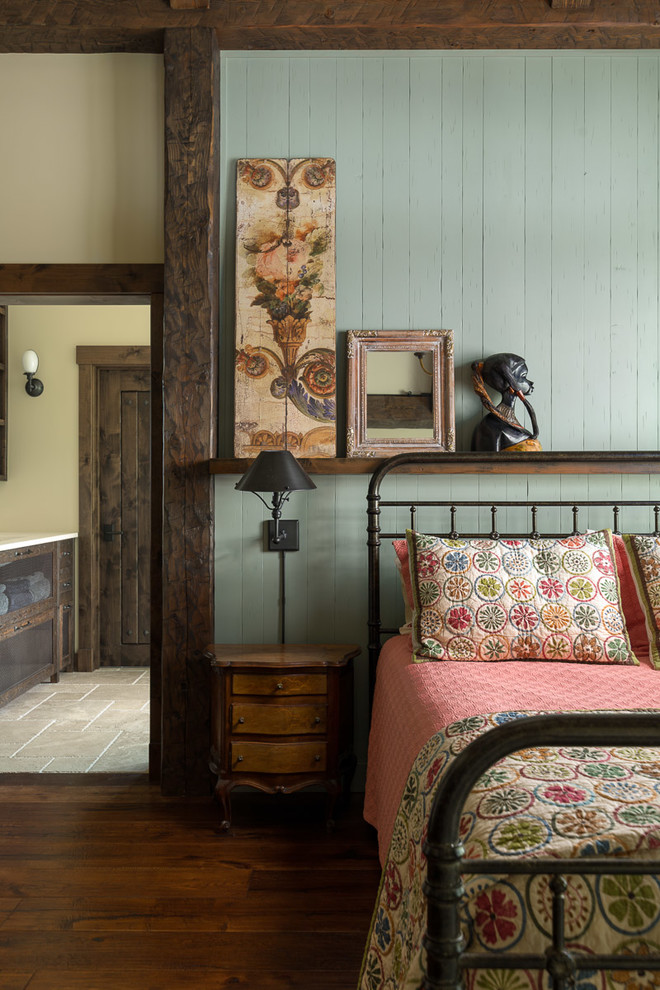 Example of a mid-sized mountain style guest medium tone wood floor and brown floor bedroom design in Jackson with green walls