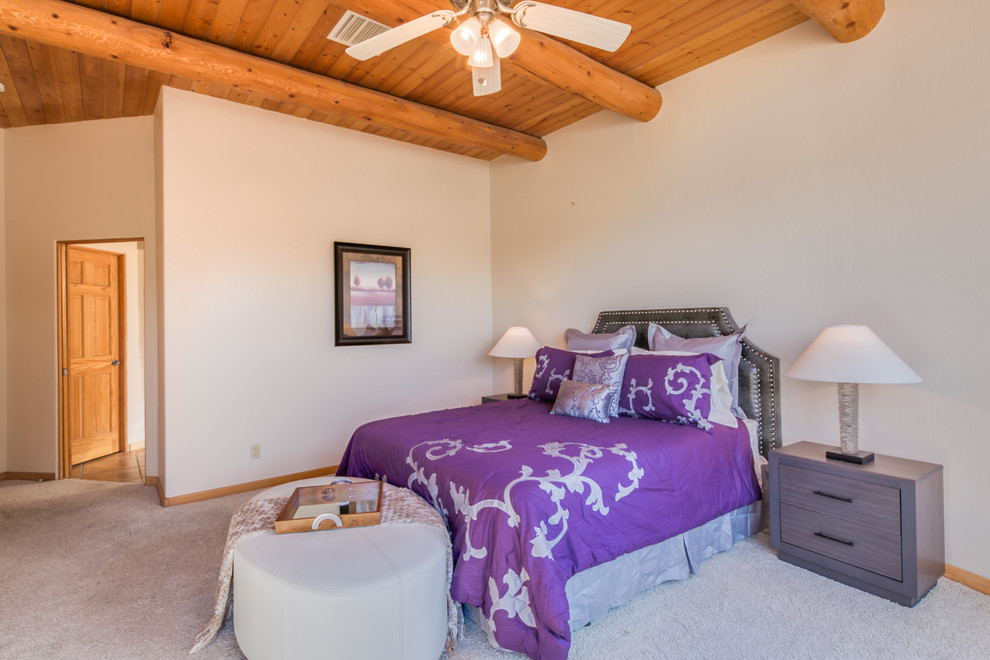Large master bedroom in Albuquerque with beige walls, carpet and no fireplace.