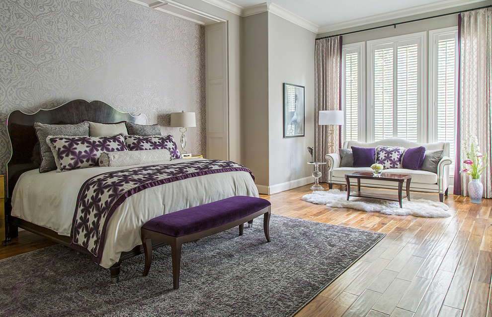 Example of a large transitional master medium tone wood floor bedroom design in Other with gray walls