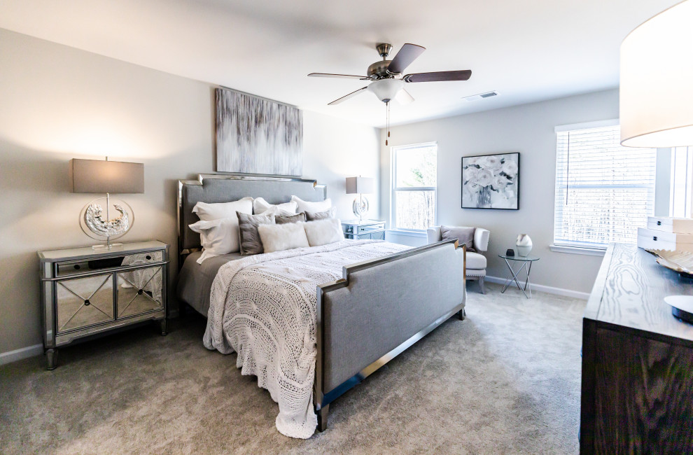 Photo of a medium sized modern master bedroom in Atlanta with beige walls, carpet and grey floors.