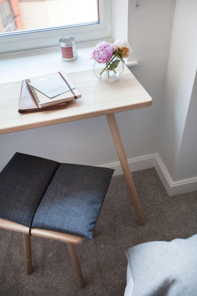 Small scandi guest bedroom in London with grey walls, carpet and grey floors.