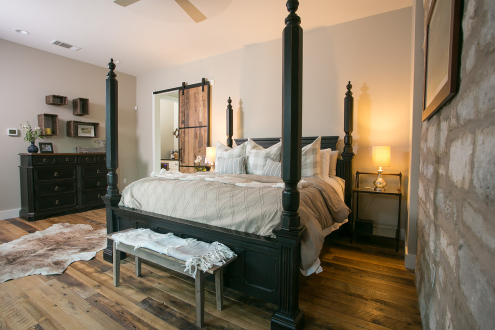 Bedroom - large cottage master medium tone wood floor and brown floor bedroom idea in Austin with beige walls