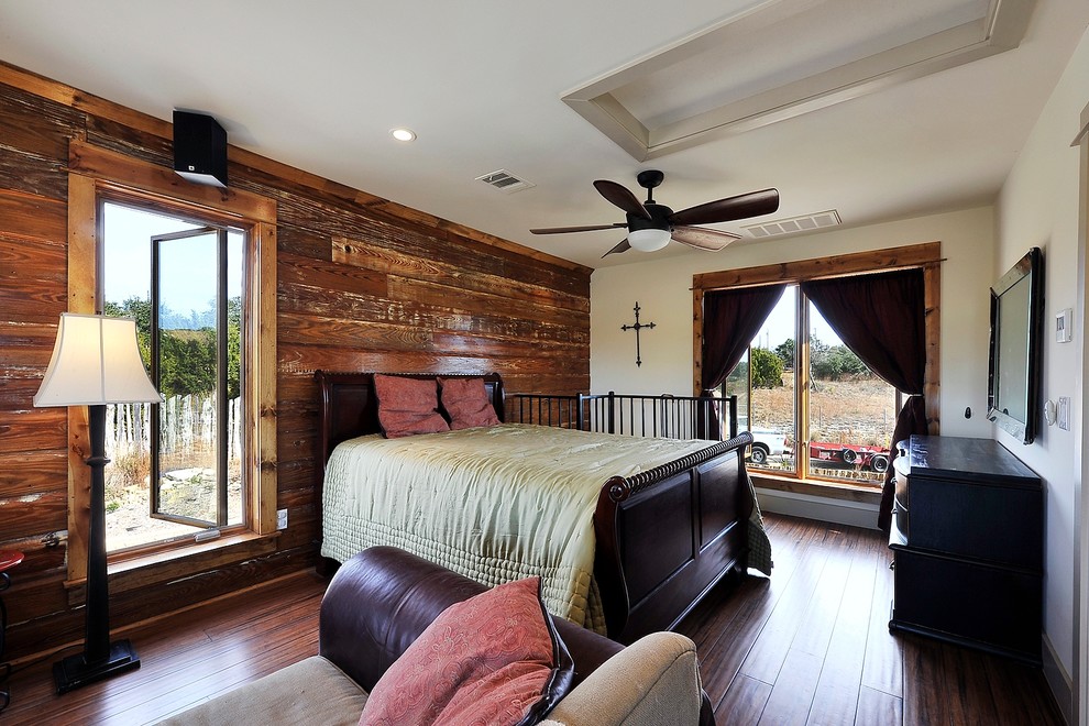 Rustic guest bedroom in Austin with white walls, dark hardwood flooring and no fireplace.