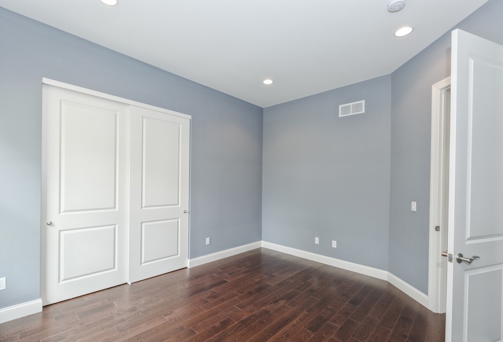Design ideas for a medium sized classic guest bedroom in St Louis with blue walls, dark hardwood flooring and brown floors.