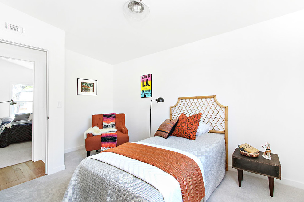 Example of an eclectic guest carpeted bedroom design in Los Angeles with white walls