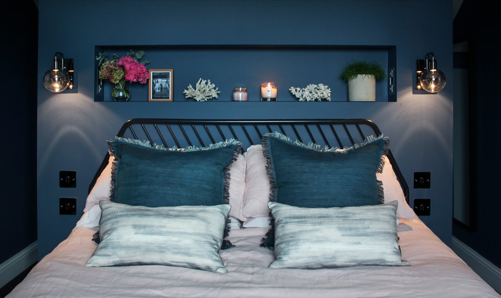 Medium sized contemporary master bedroom in London with blue walls, dark hardwood flooring and brown floors.