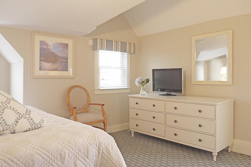Inspiration for a mid-sized coastal guest carpeted bedroom remodel in Boston with beige walls