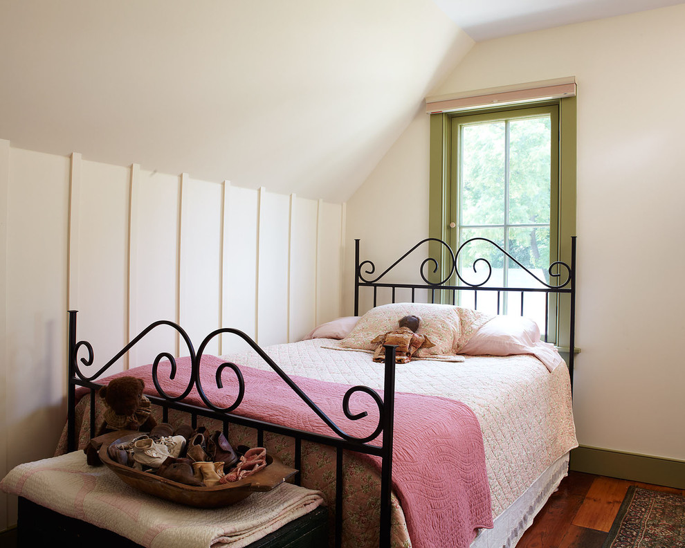 Photo of a country guest bedroom in New York with beige walls and medium hardwood flooring.