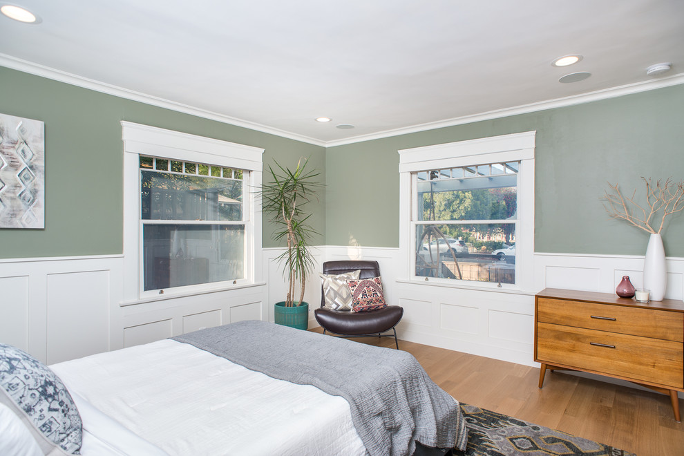 Inspiration for a medium sized classic guest bedroom in San Diego with green walls, medium hardwood flooring and brown floors.