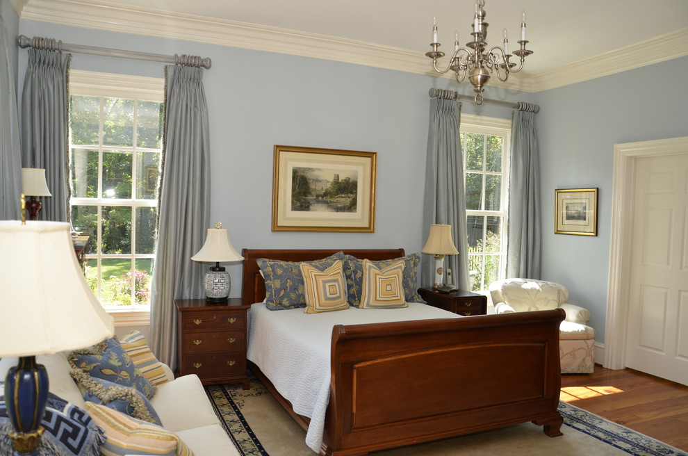 Inspiration for a classic bedroom in Atlanta with blue walls and medium hardwood flooring.