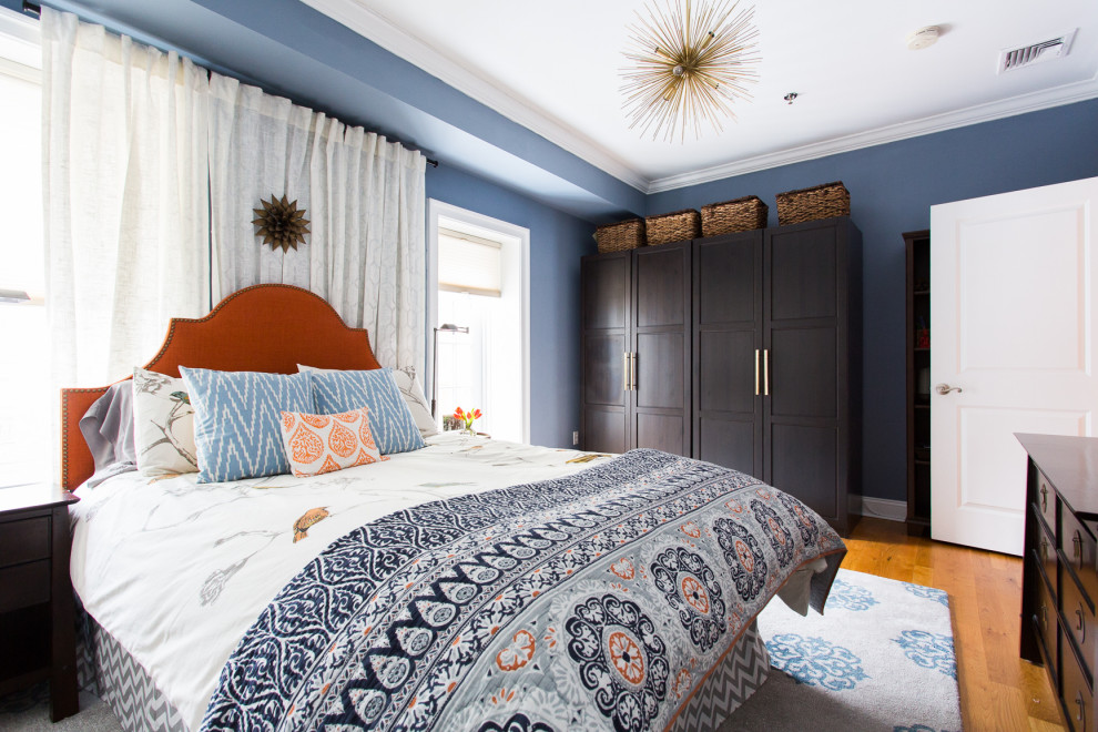 Foto de dormitorio tradicional renovado con paredes azules, suelo de madera en tonos medios y suelo marrón