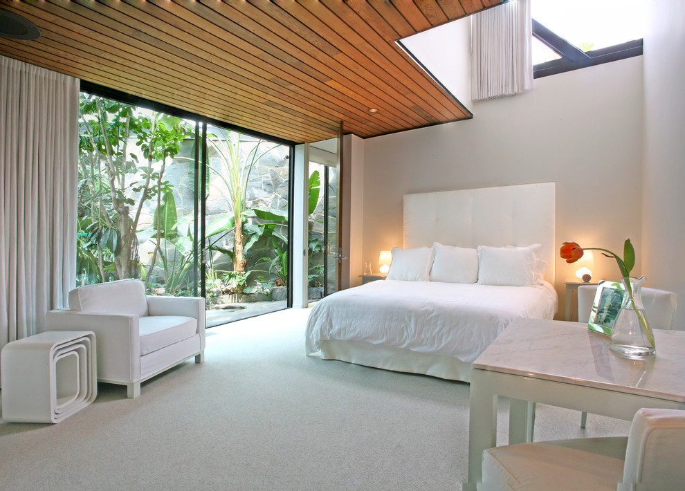 Example of a trendy carpeted bedroom design in Los Angeles with white walls